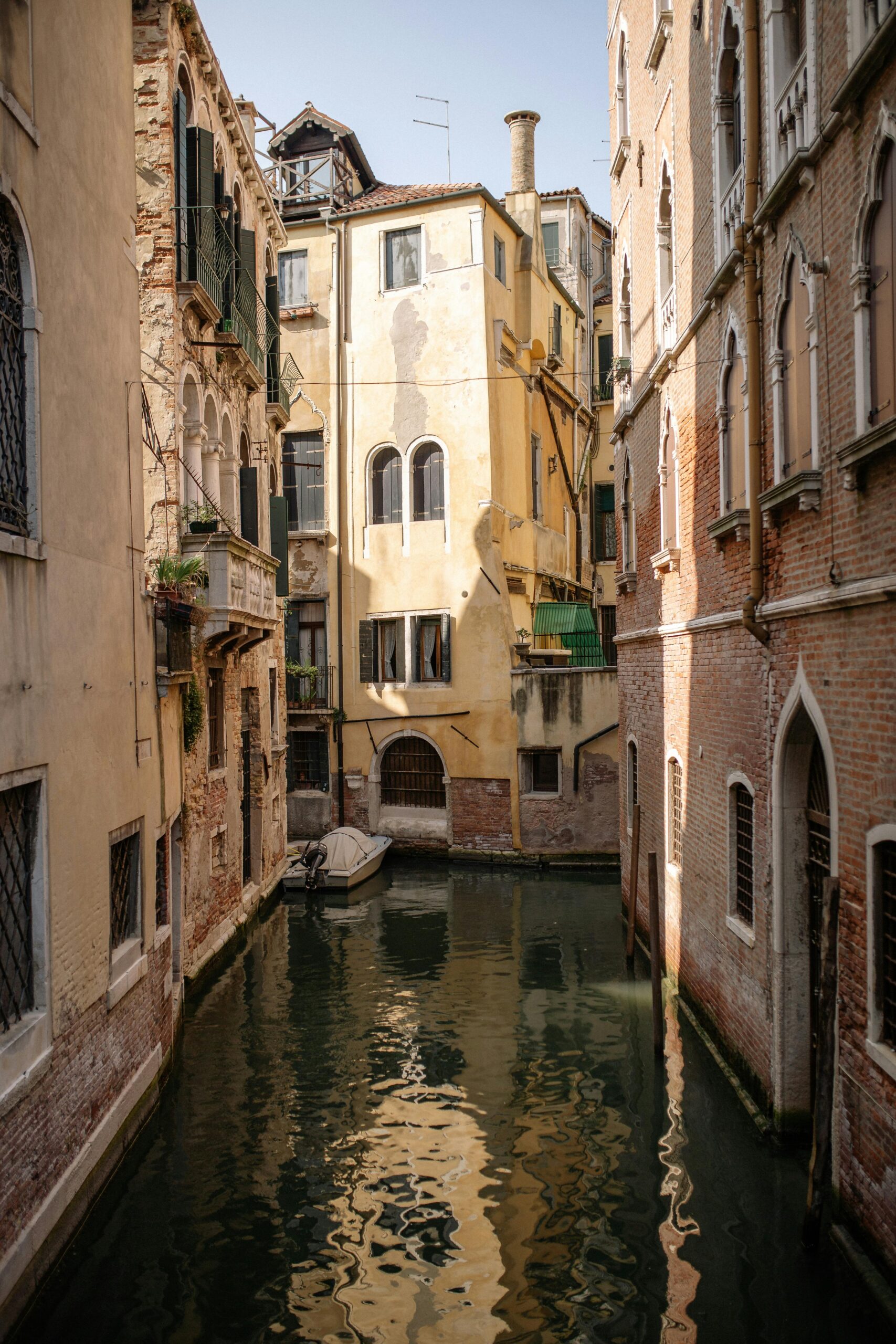 Explore the enchanting canals and historic architecture of Venice, Italy, captured in serene daylight.